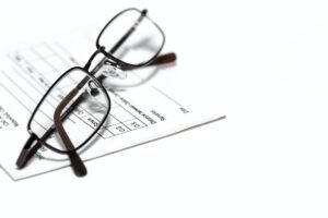 Eye glasses on a prescription pad for glasses or contact lenses Boerne Vision Center Eye glasses on a prescription pad for glasses or contact lenses