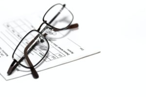 Eye glasses on a prescription pad for glasses or contact lenses