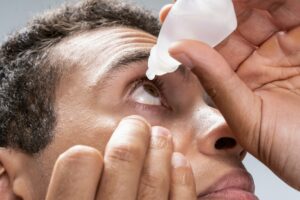 Man caring of his eyes in the morning