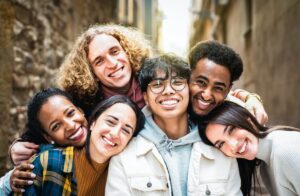 Multi racial guys and girls taking selfie outdoors with backlight