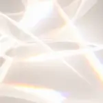 Abstract close-up of crystal-like glass with rainbow light refractions and soft highlights.